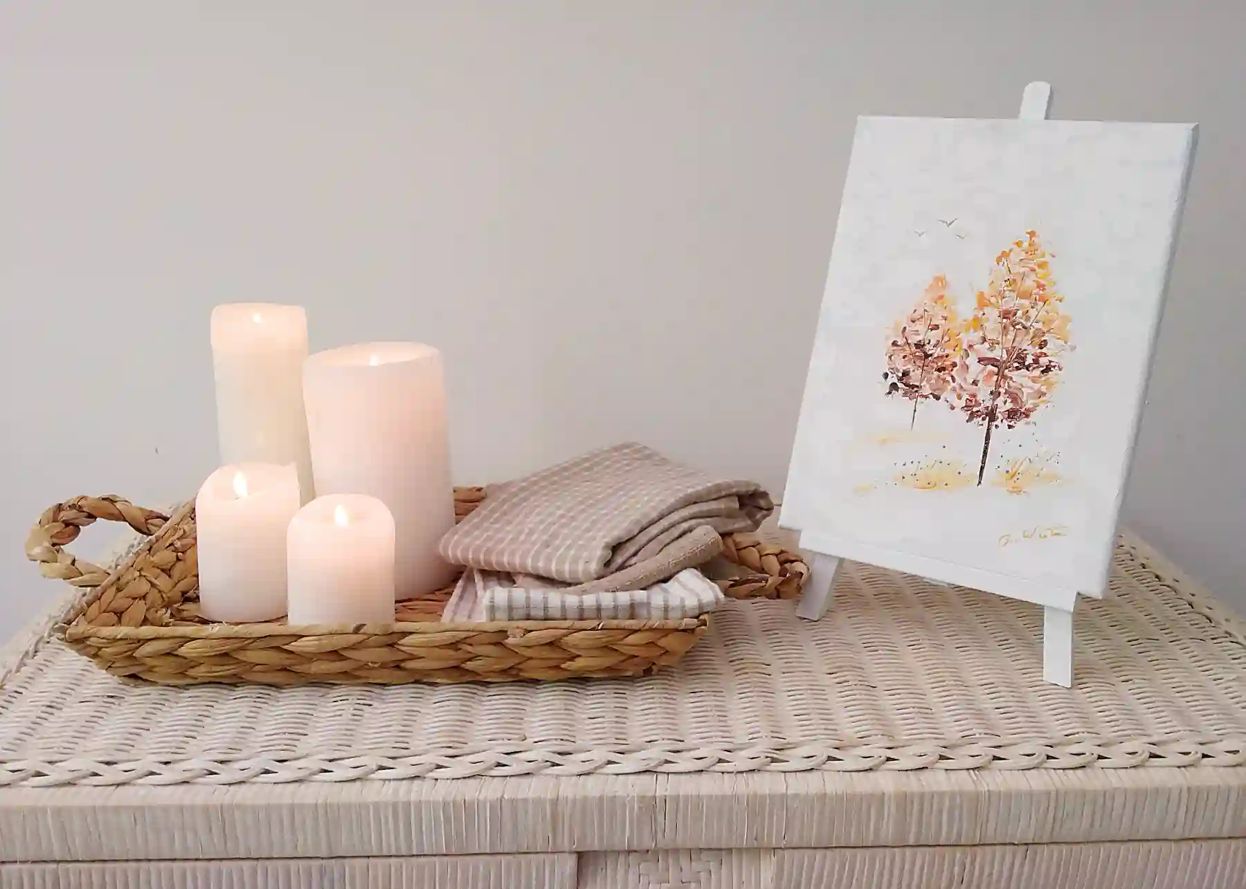 original impressionistic painting of two trees in the Pocono Mountains displayed on a table next to candles